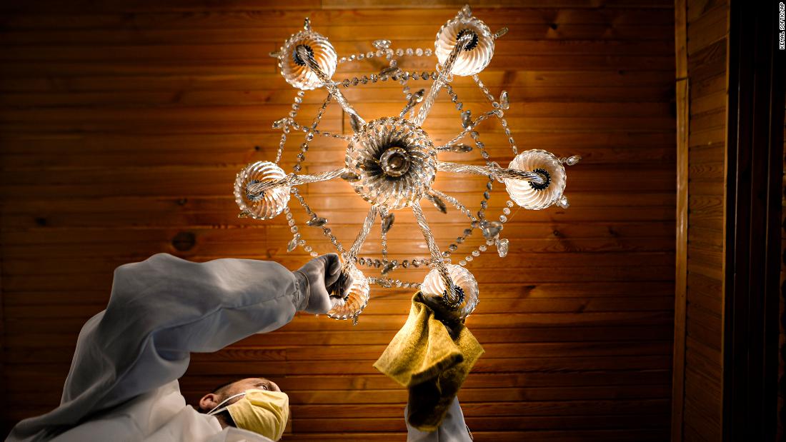 A man disinfects a ceiling lamp at the Čobanija Mosque in Sarajevo, Bosnia and Herzegovina, on April 21. 